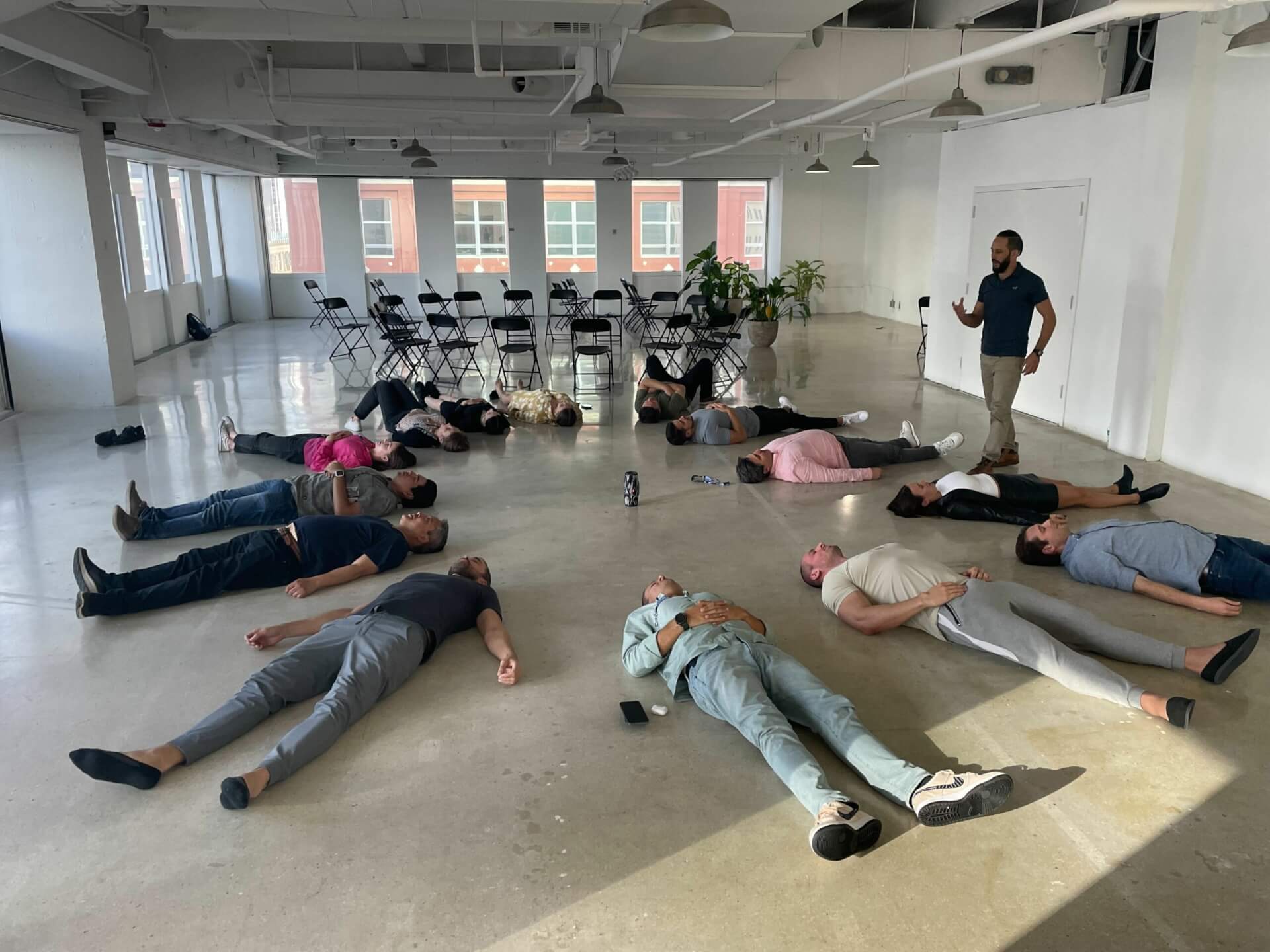 Group of people laying down in a circle